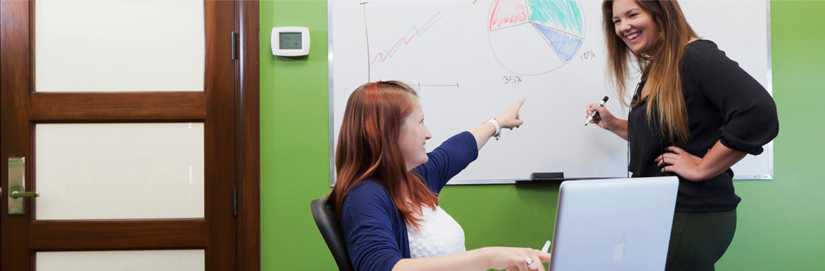 2 people reviewing a chart in a meeting